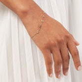 14k Yellow Gold Block Letter Name Bracelet on women's wrist